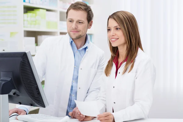 Two pharmacists fulfilling a prescription — Stock Photo, Image