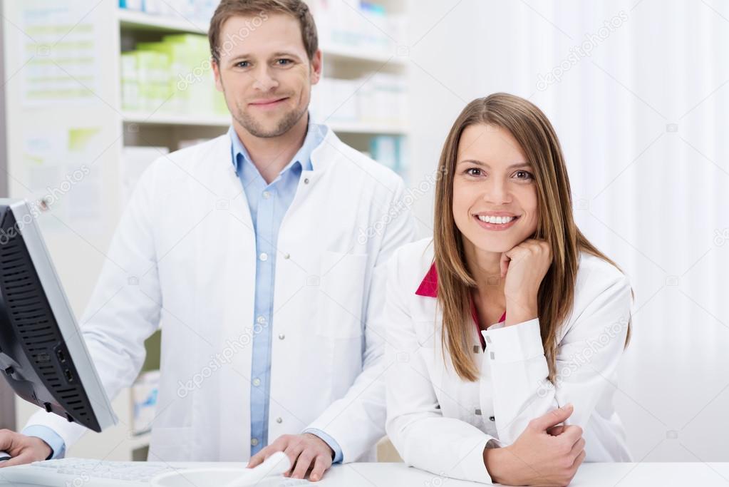 Two confident pharmacists at work Stock Photo by ©racorn 40841811
