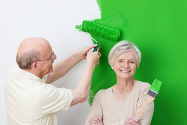 Enthusiastic senior couple renovating clipart