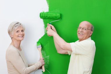 Senior couple showing off the new paint clipart