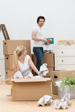 Happy young couple moving into a new home clipart