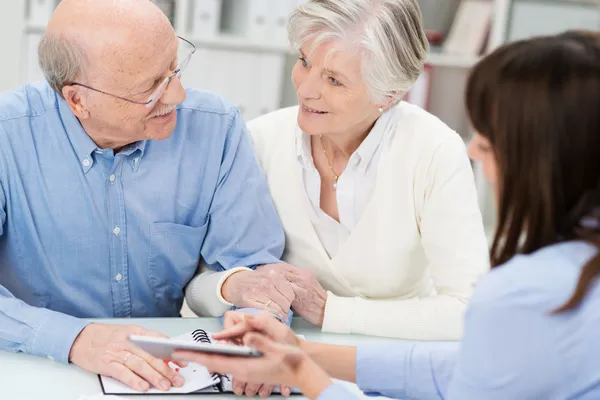 Affectionate elderly couple in a business meeting — Stock Photo, Image