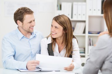 Young couple discussing an investment presentation clipart