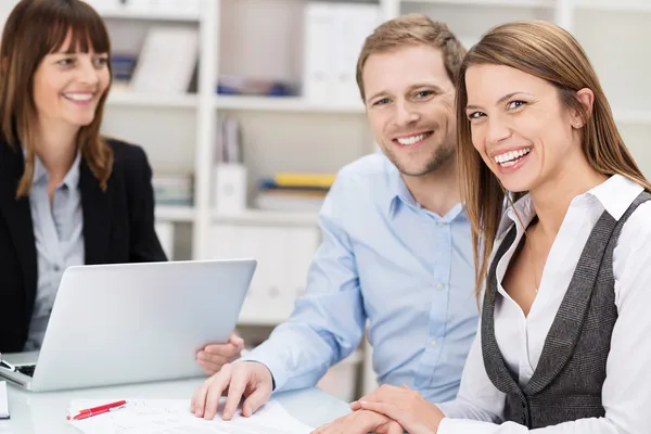 Happy confident young couple in a meeting — Stock Photo, Image