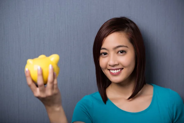 Student holding a piggy bank — Stock Photo, Image