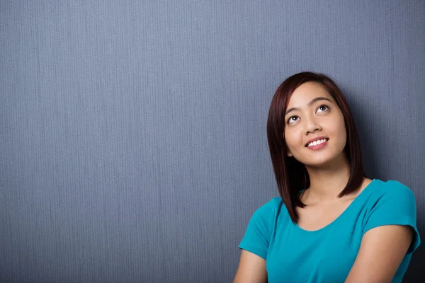 Young Asian woman lost in thought — Stock Photo, Image