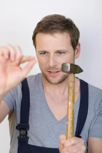 Handyman about to hammer in a nail — Stock Photo, Image