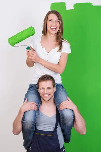 Playful young couple painting their home — Stock Photo, Image