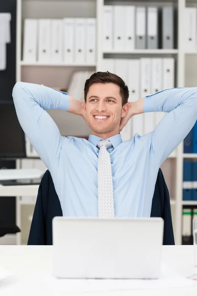 Happy businessman sitting daydreaming — Stock Photo, Image