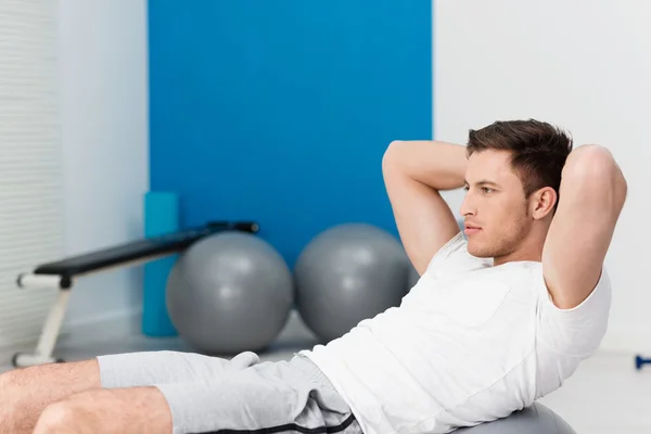 Young man working out doing pilates exercises — Stock Photo, Image
