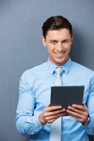 Handsome young businessman holding a tablet-pc — Stock Photo, Image