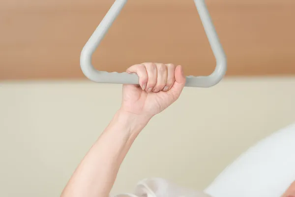 Woman gripping a mobility aid in hospital — Stock Photo, Image