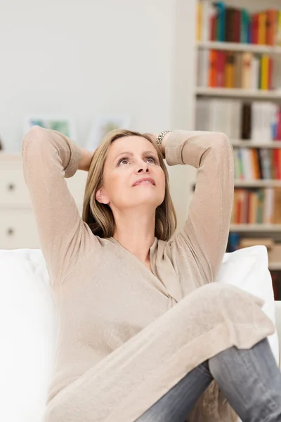 Pretty middle-aged woman sitting daydreaming — Stock Photo, Image