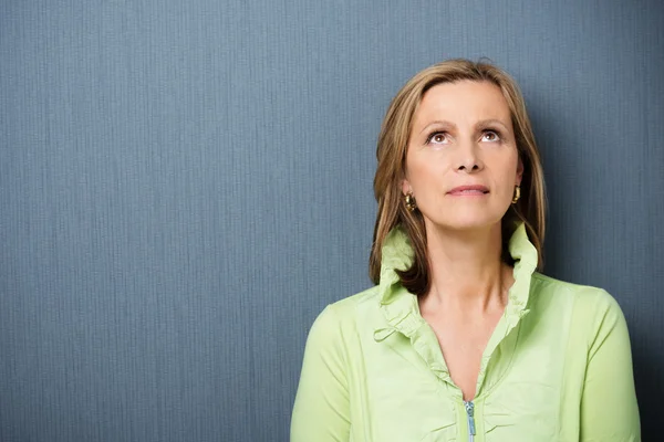 Attractive middle-aged woman daydreaming — Stock Photo, Image