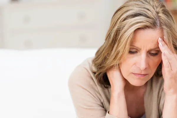 Frau leidet unter Stressgrimassen vor Schmerzen Stockbild