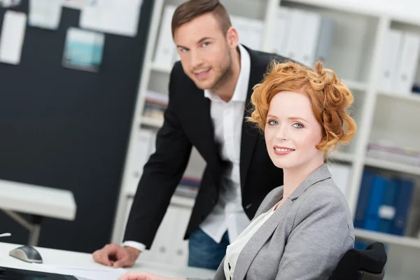 Attractive businesswoman with a male colleague — Stock Photo, Image