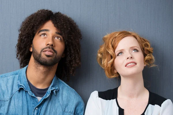 Young multiracial couple standing thinking — Stock Photo, Image