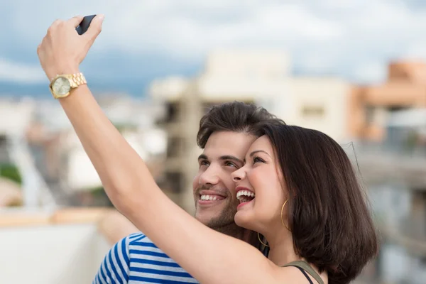 Vivacious couple taking self portrait — Stock Photo, Image