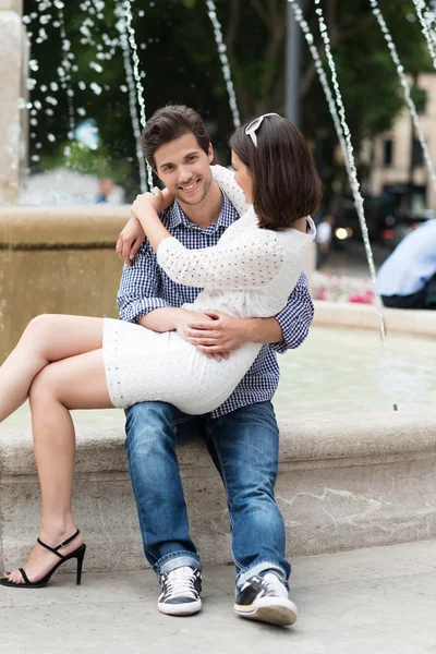 Man holding his girlfriend on lap — Stock Photo, Image