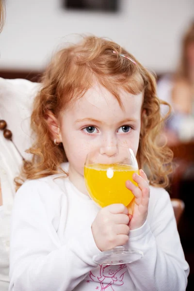 Menina beber suco de laranja — Fotografia de Stock