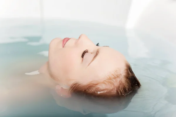 Woman soaking in bath tub — Stock Photo, Image