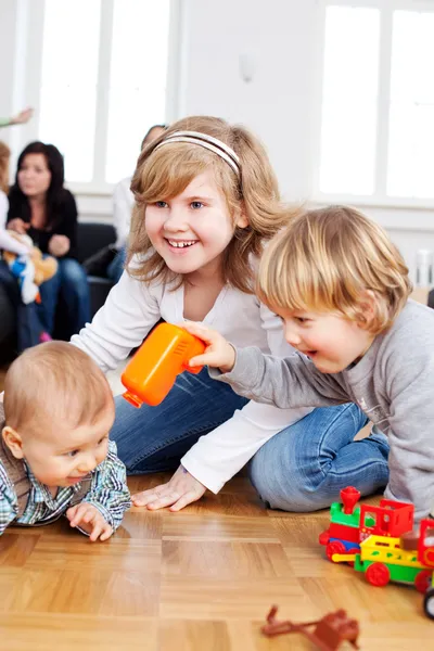 Children playing with plastic toys — Stock Photo, Image