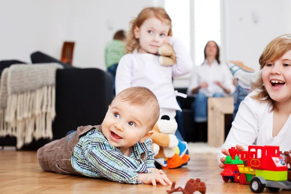 Baby boy reaching for toy — Stock Photo, Image