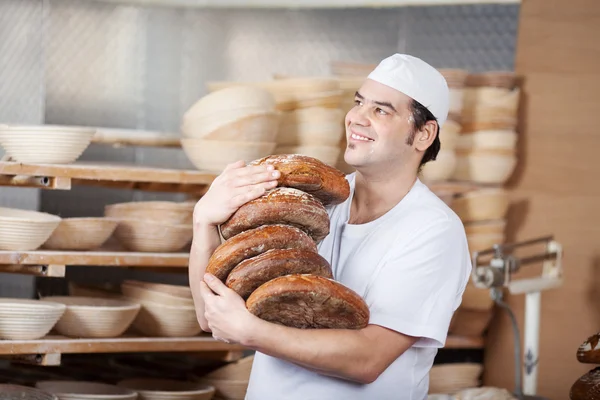 Male worker carrying breads — Stock Photo, Image