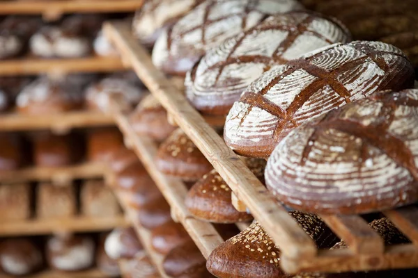 Breads displayed on shelves — Stock Photo, Image