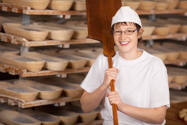 Worker holding baking spatula — Stock Photo, Image