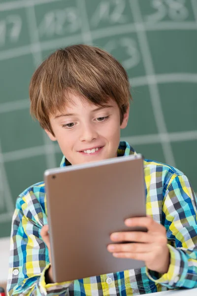 Boy using tablet in schoolroom — Stock Photo, Image