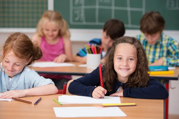 Happy young girl in class at school — Stock Photo, Image