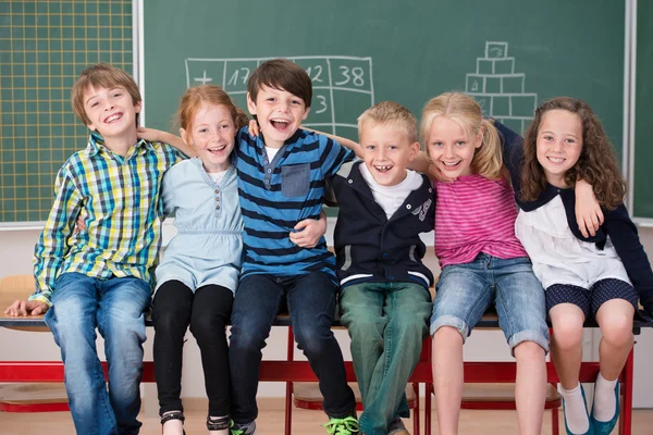 Laughing group of young friends in class — Stock Photo, Image