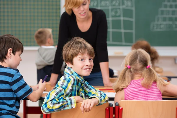 Menino na classe sorrir para a câmera — Fotografia de Stock