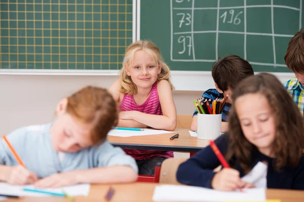 Cute pretty blond girl in class Stock Picture