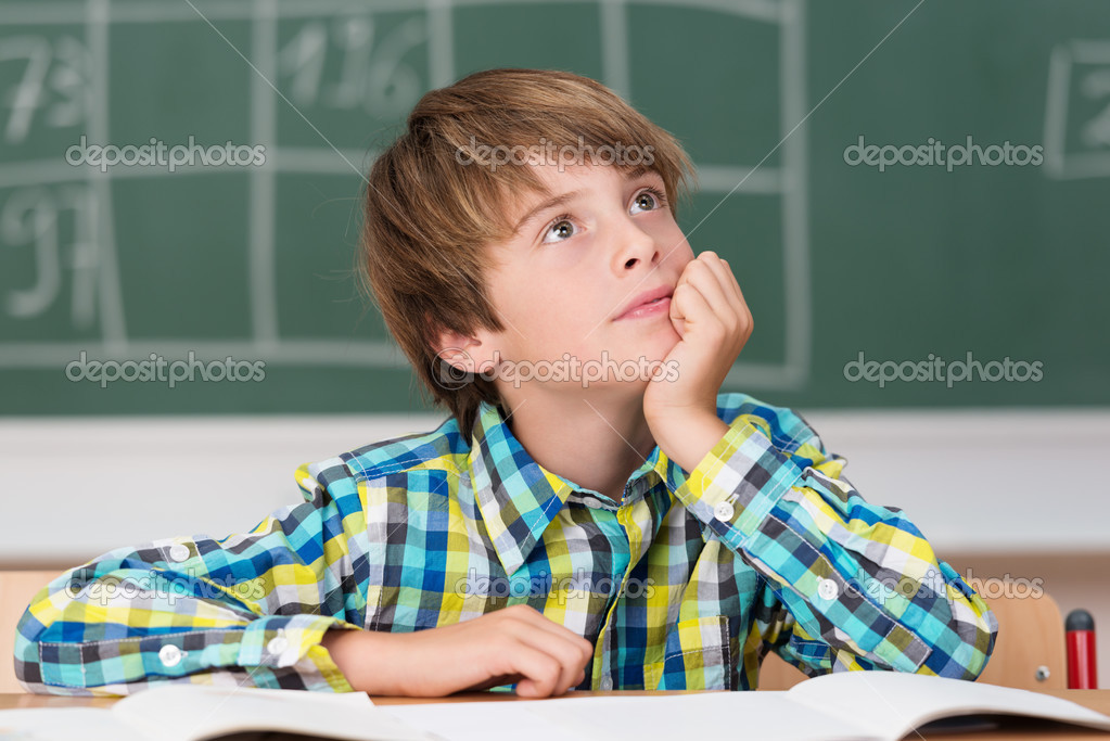 Young schoolboy daydreaming in class — Stock Photo © racorn 51323311