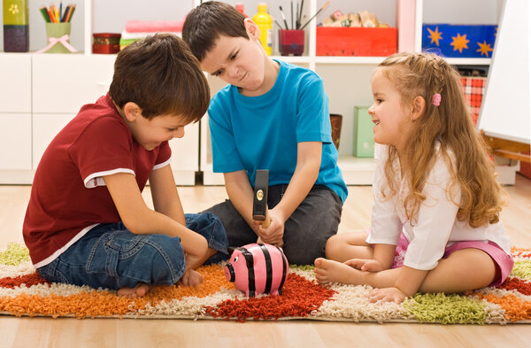 Children playing with a piggybank