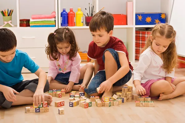 Children playing with blocks Stock Image