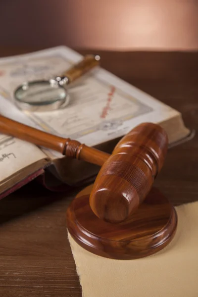 Law concept with wooden table and dark background — Stock Photo, Image