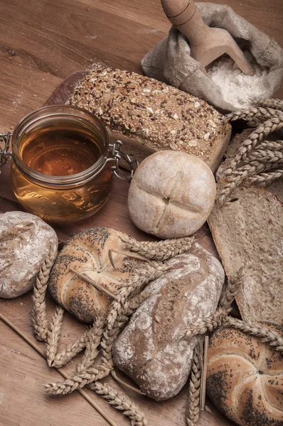 Loaves of bread, rolls, cereals with ambient light — Stock Photo, Image