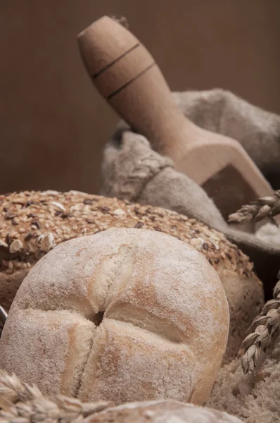 Loaves of bread, rolls, cereals with ambient light — Stock Photo, Image