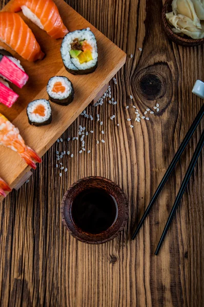 Wonderful sushi set, oriental theme on the old wooden table — Stock Photo, Image