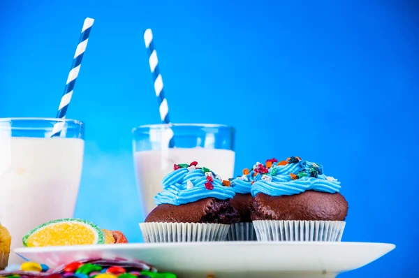 Home baked sweets on the bright, blue background — Stock Photo, Image