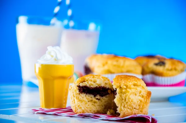 Delicious homemade muffins on blue background — Stock Photo, Image