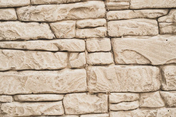 Textured background with brick particles. A wall of pieces of materials. Wall with cracks and seams. — Stock Photo, Image