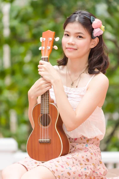 Asiática chica con ykulele guitarra al aire libre — Foto de Stock