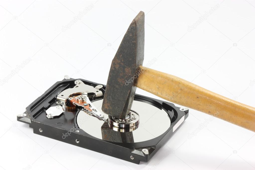 hard disk with hammer on white backgound