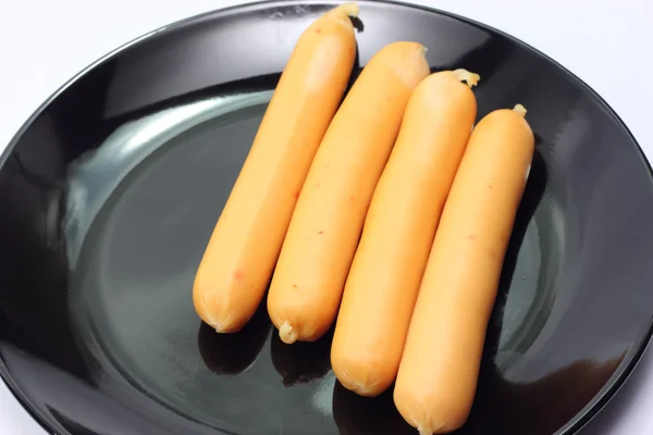 Wurst auf Teller isoliert weiß — Stockfoto