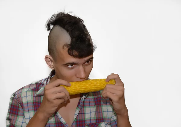 Jonge punk eet een maïs. — Stockfoto