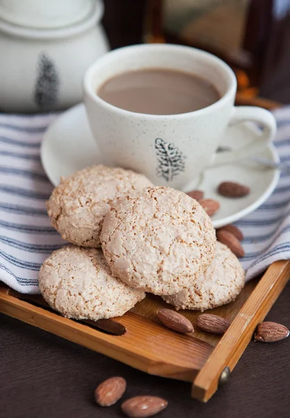 Mandlové sušenky na tácku na pozadí šálek kávy — Stock fotografie